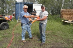 Bob VE6BLD presenting Ray VA6RSO the signed shovel handle.